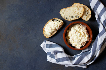 Kajmak or Kaymak. Traditional homemade white cheese. Sandwich with kajmak. Balkan cuisine. Serbian cuisine. Dark background. Top view. Space for text