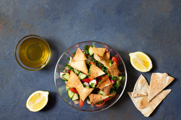 Traditional Fattoush salad  with vegetables and pita bread. Levantine, Arabic, Middle Eastern...