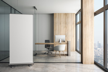 Blank white poster in modern office at glass wall background.
