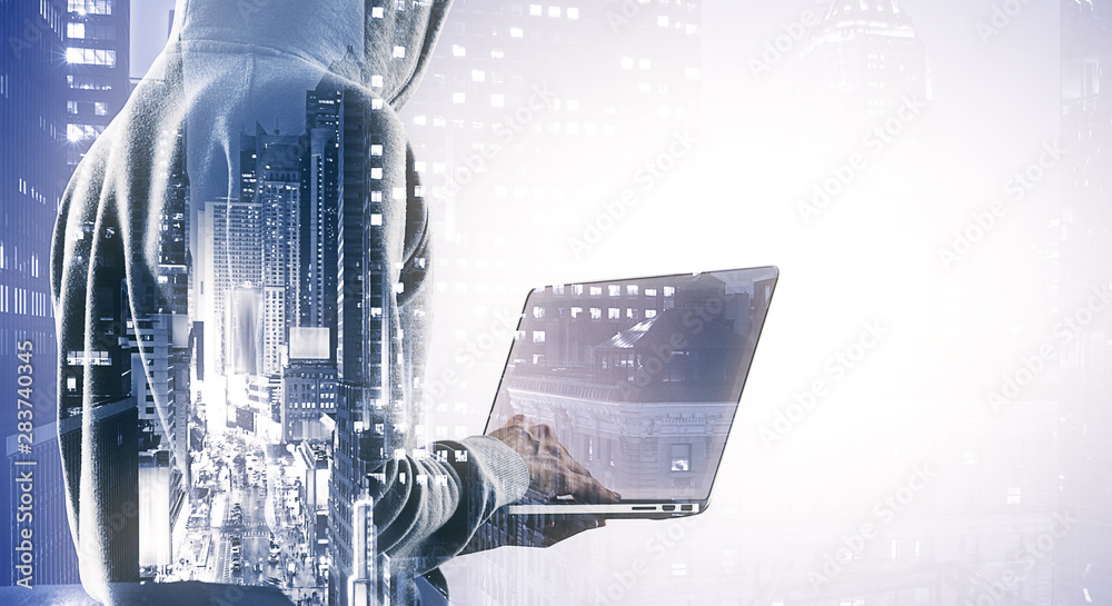 Poster Double exposure of hacker silhouette working with laptop on the background of the city, hacking and crime concept