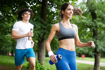 Couple jogging and running outdoors in nature