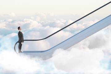 Road to success concept with businessman going up by escalator among white clouds.