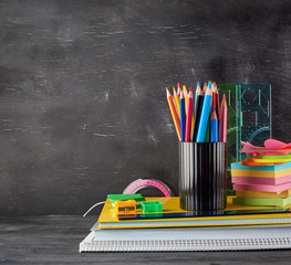 red plastic glass with colorful wooden pencils