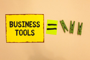 Word writing text Business Tools. Business concept for Marketing Methodologies Processes and Technologies use Yellow piece paper reminder equal sign several clothespins sending message