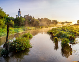 Fototapeta na wymiar Summer foggy morning on the Sherna river in the village of Filippovskoye