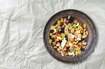 brown clay plate assorted nuts on vintage paper