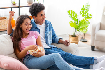 African Couple Watching Sports On Television And Cheering