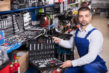 male shows box with tools