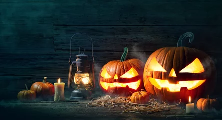 Fototapeten Halloween pumpkin head jack lantern with burning candles © Alexander Raths