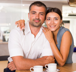 Happy couple in kitchen with keys