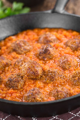 Homemade beef meatballs in fresh tomato sauce in cast-iron skillet (Selective Focus, Focus one third into the sauce)