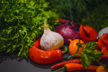 Beautiful fresh vegetables and mushrooms on a dark background