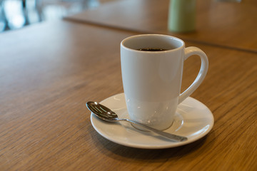 cup of coffee on wooden table