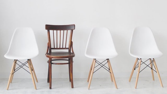 Four chairs on a white background waiting for unemployed people for an interview.