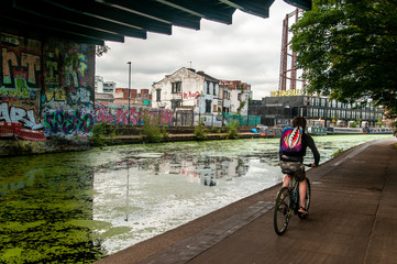 Man ride a bicycle next to the canal