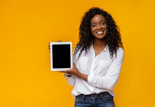 African american woman showing blank digital tablet screen