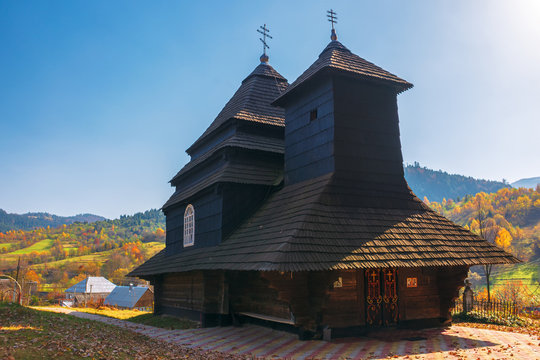 Church of the Archangel Michael - UNESCO World Heritage. old wooden building in mountains. wonderful sunny autumn weather. trees in fall foliage. cloudless sky