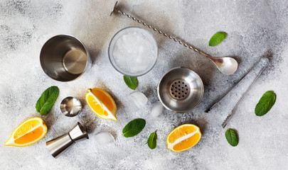 Cocktail shaker and bar tools. Ingredients for a cold alcoholic cocktail. Mojito cocktail. Lemon,...