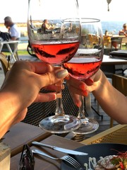 women with glasses of rose wine in restaurant