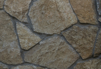 Wild stone texture photo. Old yellow wall background
