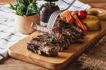 Steak on a wooden chopping board, ready to serve