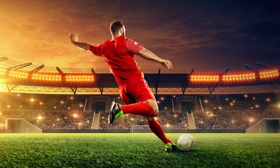 Fotobehang Soccer player kicks a ball. Night illuminated soccer stadium with dramatic sky © TandemBranding