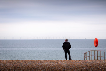 man looking at windfarms at brighton