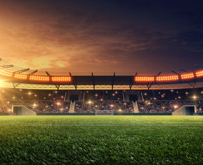 Soccer stadium with tribunes, cheering fans and dramatic night sky. 