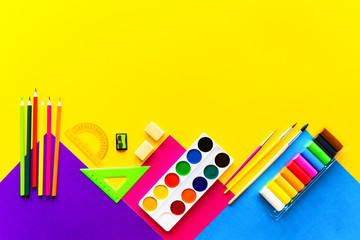 Fototapeta premium School bright supplies on a yellow background.