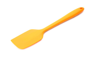 Orange silicone kitchen spatula for cooking isolated on white background with selection path.