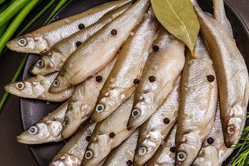 Fototapeta premium Fresh raw sea fish smelt or sardines ready for cooking
