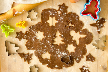 The process of making cookies and gingerbread at home. Rolled dough with carved Christmas tree pattern view from above.Homemade bakery making, New year treat for Santa Claus cooking. Homemade bakery