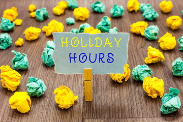 Text sign showing Holiday Hours. Conceptual photo Schedule 24 or 7 Half Day Today Last Minute Late Closing Clothespin holding gray note paper crumpled papers several tries mistakes