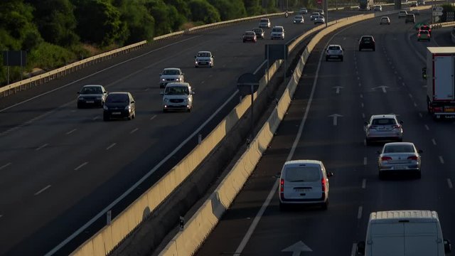 4K. Ultra HD. Aerial view of vehicles traveling the road under the afternoon light. Safe driving on the road. Engravings in the round trip. Holidays.