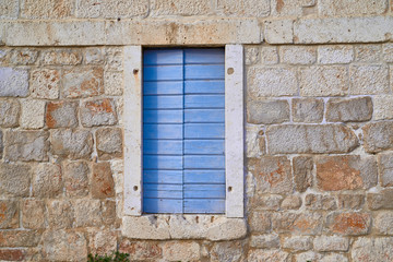Fototapeta na wymiar Wooden windows in a stone building