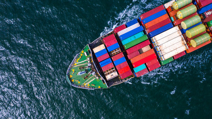 Fototapeta na wymiar Container cargo ship carrying container for business freight import and export, Aerial view container ship arriving in commercial port.