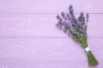 Fototapeta premium Lavender flowers on purple wooden table