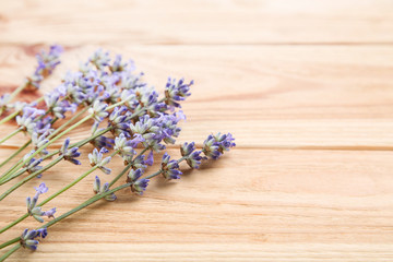 Obraz na płótnie Canvas Lavender flowers on brown wooden table