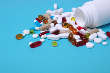 Colorful pills and tablets on blue