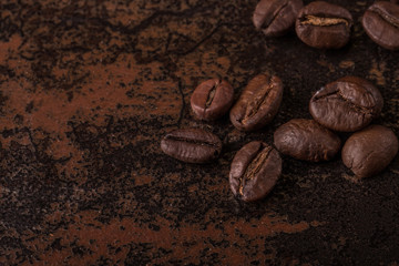 Coffee beans  on stone background. Top view with copy space for your text. Roasted coffee beans background. Beans texture, macro
