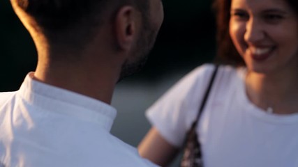 Kiss of a young man and woman at sunset in summer. Love, romance