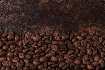Coffee beans  on stone background. Top view with copy space for your text. Roasted coffee beans background. Beans texture, macro