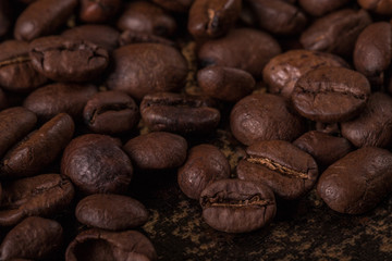 Coffee beans  on stone background. Top view with copy space for your text. Roasted coffee beans background. Beans texture, macro