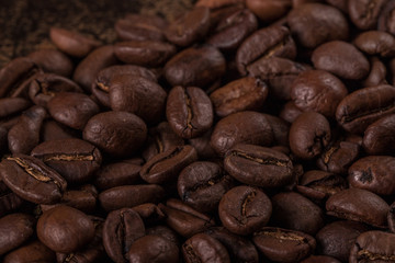 Coffee beans  on stone background. Top view with copy space for your text. Roasted coffee beans background. Beans texture, macro