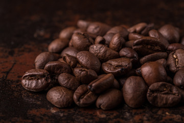 Coffee beans  on stone background. Top view with copy space for your text. Roasted coffee beans background. Beans texture, macro