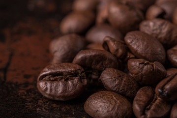 Coffee beans  on stone background. Top view with copy space for your text. Roasted coffee beans background. Beans texture, macro