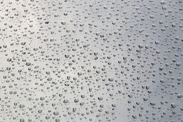 Drops of water on the surface of the auto glass.