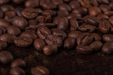 Coffee beans  on stone background. Top view with copy space for your text. Roasted coffee beans background. Beans texture, macro