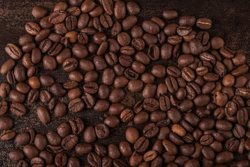 Coffee beans  on stone background. Top view with copy space for your text. Roasted coffee beans background. Beans texture, macro