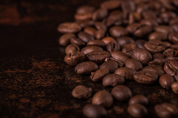 Coffee beans  on stone background. Top view with copy space for your text. Roasted coffee beans background. Beans texture, macro